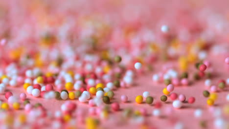 Sprinkles-falling-on-pink-surface