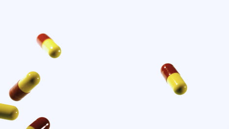 Red-and-yellow-capsule-tablets-dropping-and-bouncing