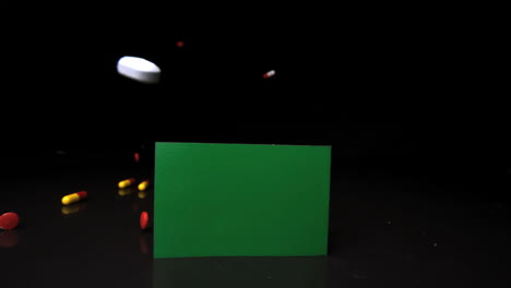 Tablets-falling-and-rolling-over-green-screen