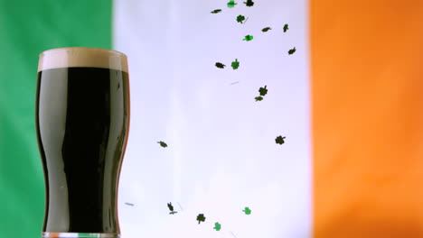 Shamrock-confetti-falling-beside-pint-of-stout