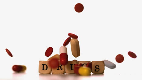 Different-tablets-falling-on-dice-spelling-drugs