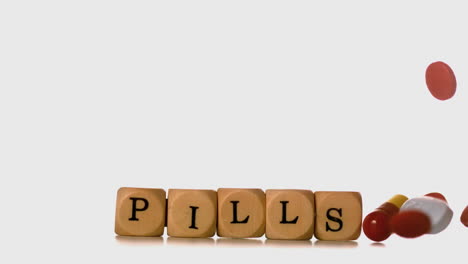 Many-types-of-pills-pouring-over-dice-spelling-pills