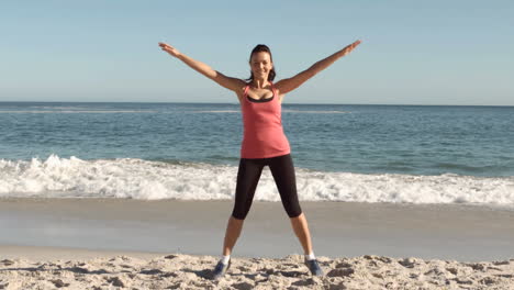 Happy-attractive-woman-working-out-on-the-beach