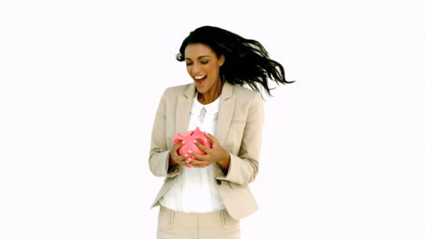 Businesswoman-jumping-and-holding-piggy-bank