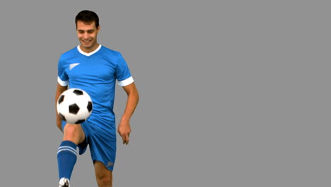 Man-playing-with-a-football-on-grey-screen
