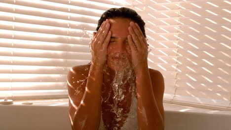 Woman-splashing-herself-with-water-in-the-bath