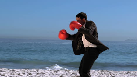 Un-Apuesto-Hombre-De-Negocios-Boxeando-En-La-Playa.