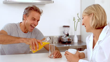 Cheerful-man-pouring-orange-juice