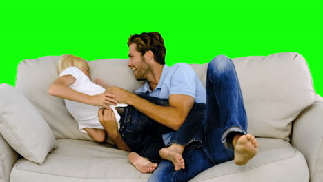 Padre-Haciendo-Cosquillas-A-Su-Hijo-En-El-Sofá-En-Pantalla-Verde