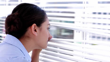 Businesswoman-spying-on-her-colleagues