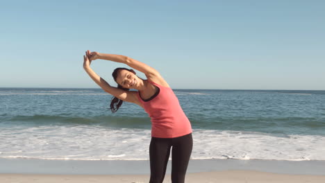 Woman-doing-exercises-on-the-beach