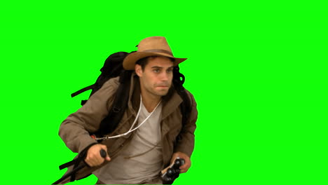 Man-orienteering-while-holding-a-hiking-stick-on-green-screen