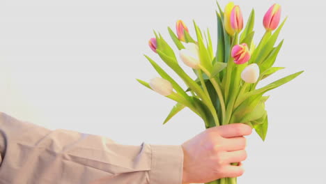 Man-offering-a-bouquet-of-tulips