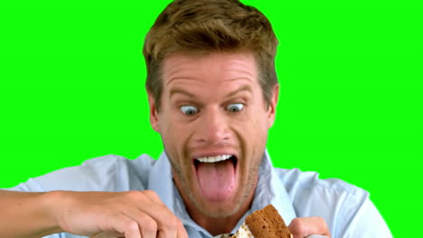 Attractive-man-about-to-eat-a-cake-on-green-screen
