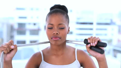 Serious-natural-model-holding-jump-rope