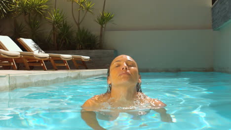Woman-emerging-from-swimming-pool