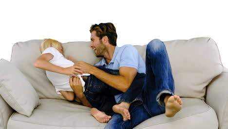 Father-tickling-son-on-the-sofa-on-white-background