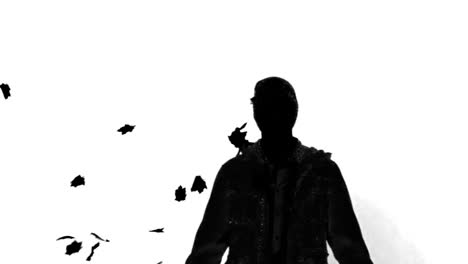 Silhouette-Eines-Mannes-Unter-Fallenden-Blättern-Auf-Weißem-Hintergrund