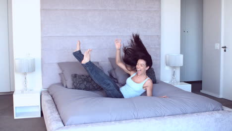 Pretty-woman-leaping-onto-bed
