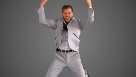 Succesful-businessman-leaping-on-grey-background