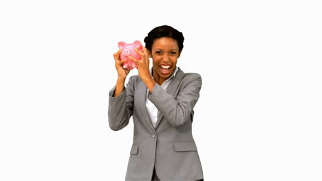 Businesswoman-listening-to-a-full-piggy-bank-on-white-screen