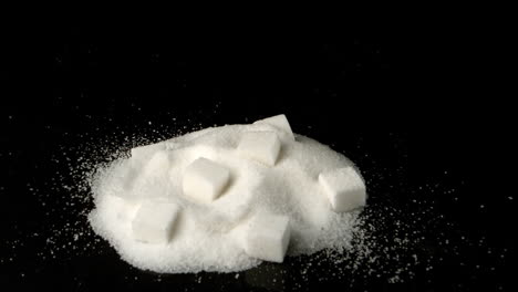 Sugar-cube-falling-in-pile-of-sugar-powder-