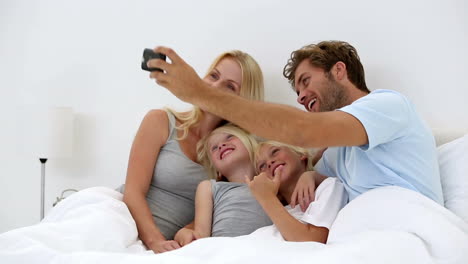 Father-taking-self-portrait-of-him-with-happy-family