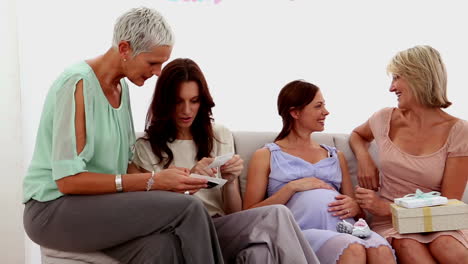 Friends-chatting-and-smiling-at-baby-shower