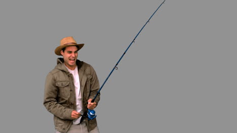 Man-making-effort-while-fishing-on-grey-screen