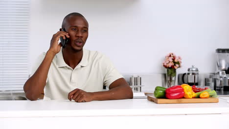 Man-in-kitchen-talking-on-the-phone