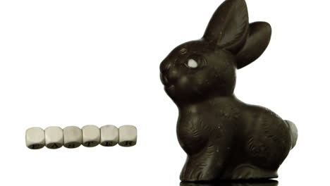 Letters-spelling-out-easter-falling-beside-chocolate-bunny