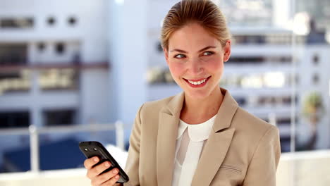 Portrait-of-smiling-businesswoman-text-messaging