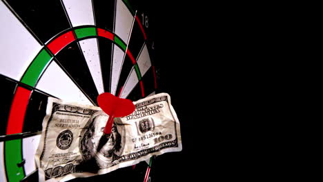 Red-dart-with-a-dollar-note-hitting-dart-board