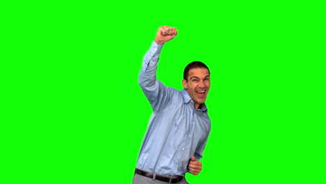 Cheerful-businessman-raising-his-fist-on-green-screen
