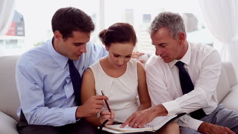 Businessmen-pointing-at-a-colleagues-diary