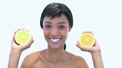 Beautiful-woman-holding-slices-of-orange