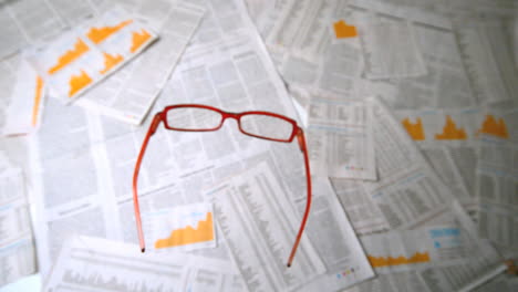 Glasses-falling-on-papers