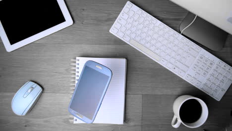 Smartphone-phone-falling-on-office-desk-in-black-and-white