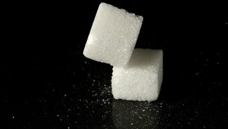 Sugar-cubes-falling-on-hard-surface