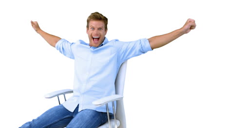 Man-on-swivel-chair-raising-arms-to-show-his-success-on-white-screen