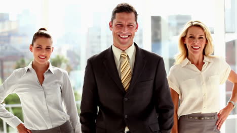 Three-smiling-business-people-posing
