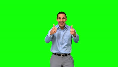 Cheerful-businessman-giving-thumbs-up-on-green-screen