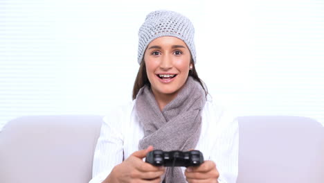 Smiling-brunette-playing-video-games-
