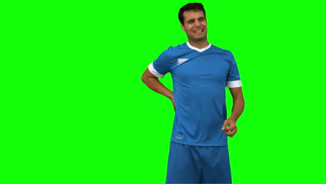 Football-player-suffering-from-back-pain-on-green-screen