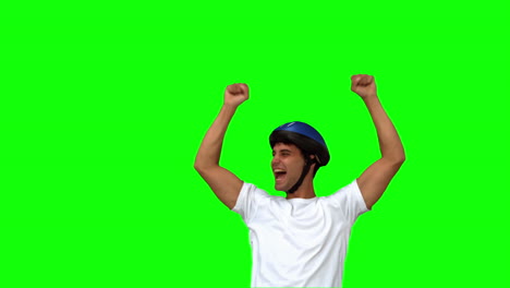 Man-on-his-bicycle-raising-arms-on-green-screen