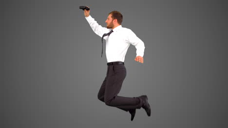 Businessman-leaping-and-holding-tablet-on-grey-background