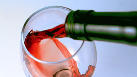 High-angle-shot-of-red-wine-being-poured-into-glass
