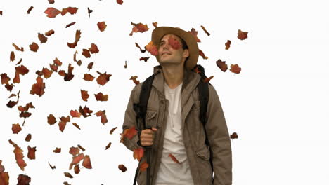 Man-standing-under-leaves-falling-on-white-screen