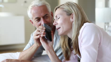 Man-jokingly-taking-phone-off-partner-talking