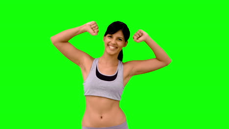 Athletic-woman-tensing-her-arms-on-green-screen